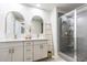 Modern bathroom with double vanity, gold framed mirrors, decorative ladder, and glass enclosed shower at 1704 Hyssop Se Blvd, Smyrna, GA 30126
