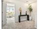 Hallway featuring a decorative console table, greenery, and view to office with lots of natural light at 1704 Hyssop Se Blvd, Smyrna, GA 30126