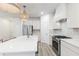 Bright kitchen featuring an island with seating, modern countertops, and stainless steel appliances at 1704 Hyssop Se Blvd, Smyrna, GA 30126