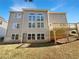 Exterior rear view of the home with a wooden deck overlooking the grassy backyard, all under a clear blue sky at 2577 Ozella Sw Pl, Atlanta, GA 30331