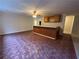Finished basement bar area with wooden paneling and unique patterned floors at 2577 Ozella Sw Pl, Atlanta, GA 30331