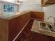 Cozy bar area features dark wood paneling, tile countertops, wood floors, and stainless sink at 2577 Ozella Sw Pl, Atlanta, GA 30331