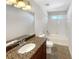 Bathroom featuring granite countertop, tile floors, and a tub-shower combo at 2577 Ozella Sw Pl, Atlanta, GA 30331