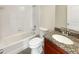 Bright bathroom features a shower-tub combo and granite countertop vanity at 2577 Ozella Sw Pl, Atlanta, GA 30331