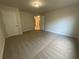 Empty carpeted room with neutral walls and a view into an adjoining room at 2577 Ozella Sw Pl, Atlanta, GA 30331