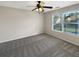 Clean bedroom features a ceiling fan, neutral carpet, and window with neighborhood views at 2577 Ozella Sw Pl, Atlanta, GA 30331