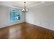 Dining room with hardwood floors, wainscoting, and a modern chandelier fixture at 2577 Ozella Sw Pl, Atlanta, GA 30331