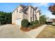 Spacious home featuring a large driveway, side-entry garage, and professionally landscaped front yard at 2577 Ozella Sw Pl, Atlanta, GA 30331