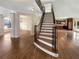 Grand foyer with staircase featuring hardwood floors and iron spindles at 2577 Ozella Sw Pl, Atlanta, GA 30331