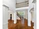 Grand foyer featuring hardwood floors, soaring ceilings, staircase, and elegant architectural details at 2577 Ozella Sw Pl, Atlanta, GA 30331