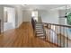 Second story hallway with beautiful hardwood floors overlooking the great room below at 2577 Ozella Sw Pl, Atlanta, GA 30331