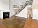 Inviting living room with fireplace, gleaming hardwood floors, and staircase to second level at 2577 Ozella Sw Pl, Atlanta, GA 30331