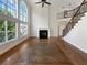 Bright living room with soaring ceilings, large windows, fireplace, and staircase at 2577 Ozella Sw Pl, Atlanta, GA 30331