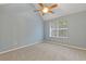 Bedroom featuring neutral-colored walls, carpet, and a large window for natural light at 2907 Oakvale Falls Dr, Decatur, GA 30034