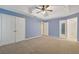 Spacious bedroom featuring carpet floors, neutral walls, ceiling fan and attached bathroom at 2907 Oakvale Falls Dr, Decatur, GA 30034
