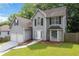Traditional two-story home featuring a two-car garage, fenced yard, and manicured lawn at 2907 Oakvale Falls Dr, Decatur, GA 30034