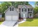 Charming two-story home with a two-car garage and a well-manicured lawn at 2907 Oakvale Falls Dr, Decatur, GA 30034