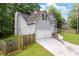 View of the home showing the driveway leading to a two-car garage and fenced yard at 2907 Oakvale Falls Dr, Decatur, GA 30034