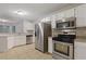 Bright kitchen features stainless steel appliances, white cabinets, and tile flooring at 2907 Oakvale Falls Dr, Decatur, GA 30034