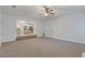 Living room with carpeted floors, a ceiling fan and a view into the kitchen at 2907 Oakvale Falls Dr, Decatur, GA 30034