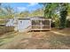Exterior view of house with screened-in porch and large leafy backyard at 1686 Alvarado Sw Ter, Atlanta, GA 30310