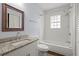 Bathroom features updated granite-top vanity and a shower-tub combo with tiled walls at 1686 Alvarado Sw Ter, Atlanta, GA 30310