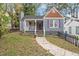 Charming home featuring grey siding, purple shutters, and a well-manicured front yard at 1686 Alvarado Sw Ter, Atlanta, GA 30310