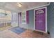 Charming front porch with brick flooring, a purple door, and matching window shutters at 1686 Alvarado Sw Ter, Atlanta, GA 30310