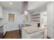 Modern kitchen featuring an island with granite countertop and stainless steel appliances at 1686 Alvarado Sw Ter, Atlanta, GA 30310