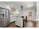 Kitchen featuring a center island, stainless steel appliances, and white cabinets at 1686 Alvarado Sw Ter, Atlanta, GA 30310