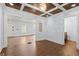 Living room with hardwood floors, coffered ceiling with chandelier, and natural light at 1686 Alvarado Sw Ter, Atlanta, GA 30310