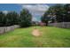 A spacious backyard showcasing a grassy lawn and a shed with a basketball hoop at 1801 Deer Crossing Cir, Jonesboro, GA 30236