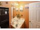 Cozy half bathroom featuring neutral wall color, single sink vanity, decorative mirror and charming decor at 1801 Deer Crossing Cir, Jonesboro, GA 30236