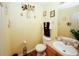 Charming half-bath features wood-look flooring and decorative accents throughout at 1801 Deer Crossing Cir, Jonesboro, GA 30236