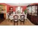 Elegant dining room with red walls, chandelier, china cabinet, and table set for a formal meal at 1801 Deer Crossing Cir, Jonesboro, GA 30236