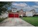 Charming two-story brick home featuring a two-car garage and a well-maintained front lawn in a suburban neighborhood at 1801 Deer Crossing Cir, Jonesboro, GA 30236