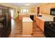 Modern kitchen featuring stainless steel refrigerator, center island and hardwood flooring throughout at 1801 Deer Crossing Cir, Jonesboro, GA 30236
