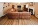 Spacious living room featuring a large leather sofa and a cozy fireplace at 1801 Deer Crossing Cir, Jonesboro, GA 30236