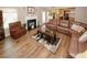 Comfortable living room with a fireplace, leather sofa, and hardwood floors, creating a cozy and welcoming atmosphere at 1801 Deer Crossing Cir, Jonesboro, GA 30236