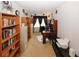 Home office with built in shelving, desk with computer and window with black curtains at 1801 Deer Crossing Cir, Jonesboro, GA 30236