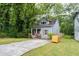 Cozy home with inviting curb appeal, lush trees, and plenty of parking at 3111 Jones St, East Point, GA 30344