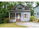 Charming home with a covered front porch, neat yard, and light blue exterior at 3111 Jones St, East Point, GA 30344