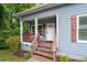 Inviting front porch with decorative columns and warm wood accents for relaxing outdoors at 3111 Jones St, East Point, GA 30344