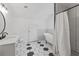 Updated bathroom featuring black and white tile and a clawfoot tub at 3111 Jones St, East Point, GA 30344