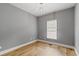 Simple bedroom with hardwood floors and natural light, offering a serene and minimalist space at 3111 Jones St, East Point, GA 30344