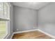 Neutral bedroom with a large window and hardwood floors, providing a blank canvas for personalization at 3111 Jones St, East Point, GA 30344
