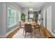 Bright dining room features hardwood floors, natural light and an adjacent view of the kitchen at 3111 Jones St, East Point, GA 30344