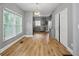 Dining room features hardwood floors, natural light and an adjacent view of the kitchen at 3111 Jones St, East Point, GA 30344