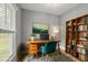Cozy home office featuring a wooden desk, shelving, and natural light, perfect for working from home at 3111 Jones St, East Point, GA 30344