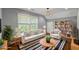 Inviting living room with neutral furniture, shelving, and natural light at 3111 Jones St, East Point, GA 30344